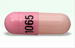 Pill 1065 Pink Capsule/Oblong is Clomipramine Hydrochloride